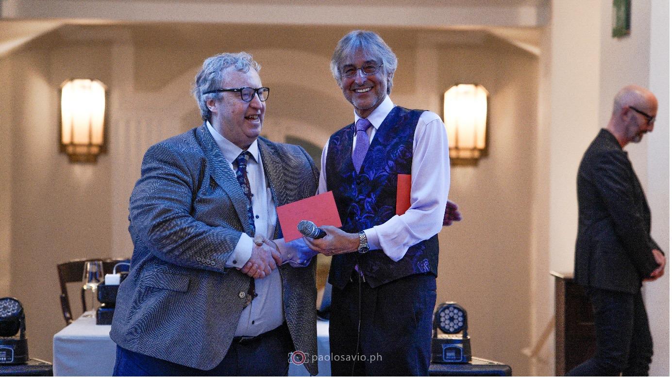 Brian Kavanagh (left) receives a retirement gift from Paull Khan