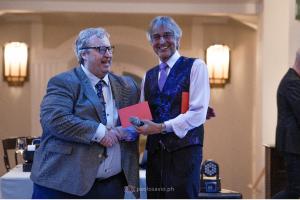Brian Kavanagh (left) receives a retirement gift from Paull Khan